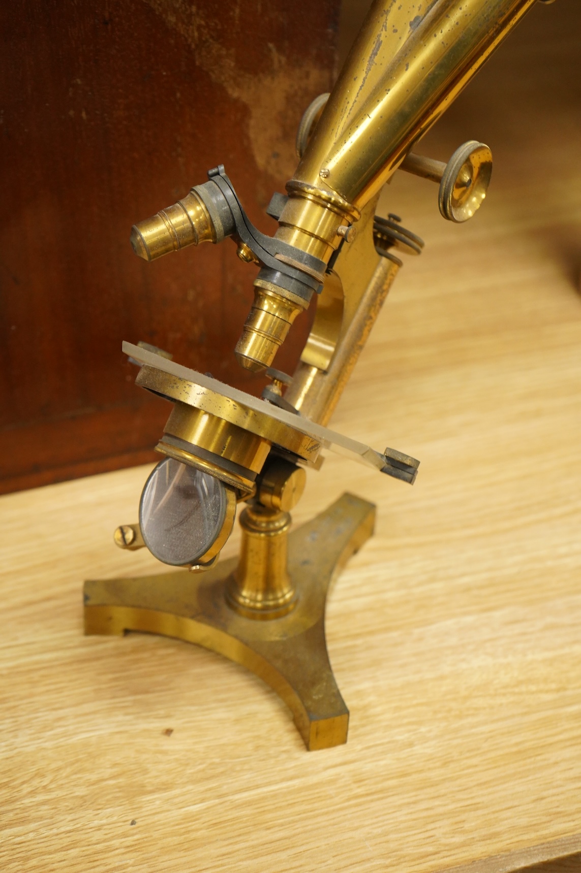 A late 19th century brass compound binocular microscope, by R. & J. Beck, London, number 13654, mahogany cased, together with accessories, including a pair of eye pieces and three objectives. Instrument height 39cm